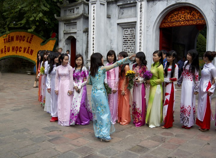 Girls posing in front of the Temple of Literature, Hanoi, Vietnam.