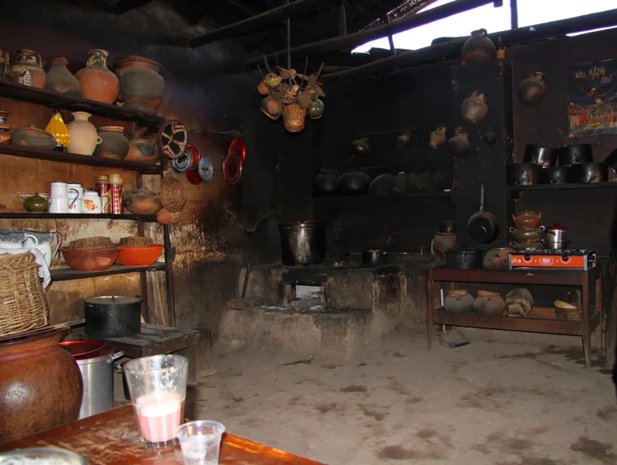 The chicharia - Flora's kitchen. Packed dirt floors and fire charred walls...