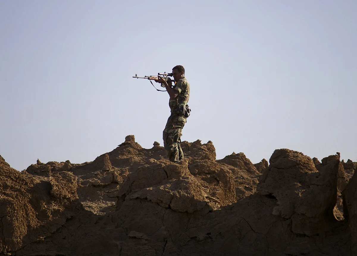Ethiopian militia, assigned to guard travelers in the Dallol area, scope out the area for potential threats.