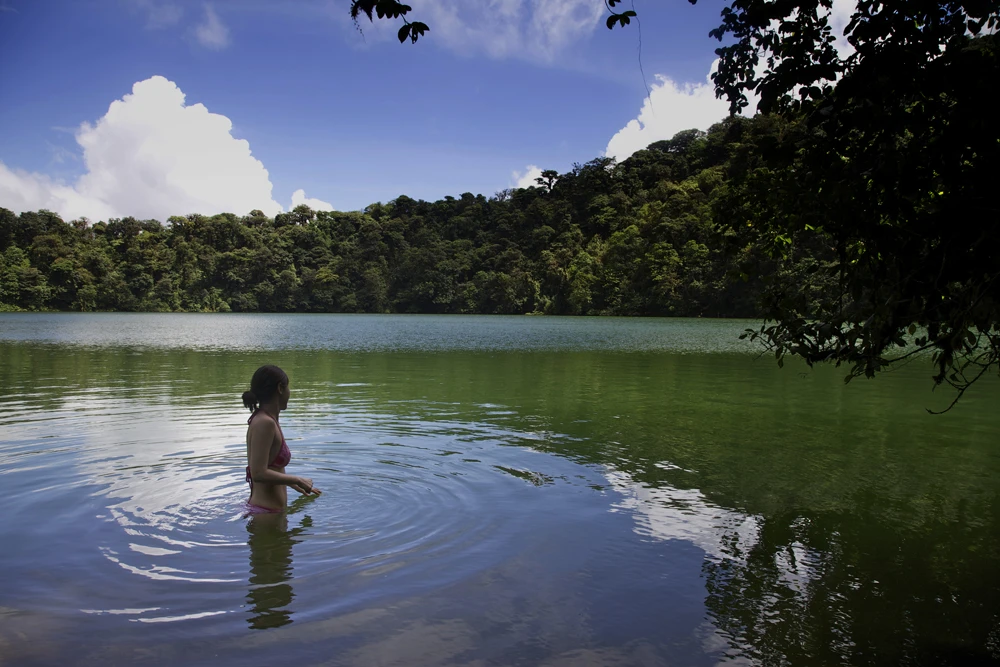 Joyce taking a dip in the emerald green lagoon of Cerro Chato’s crater