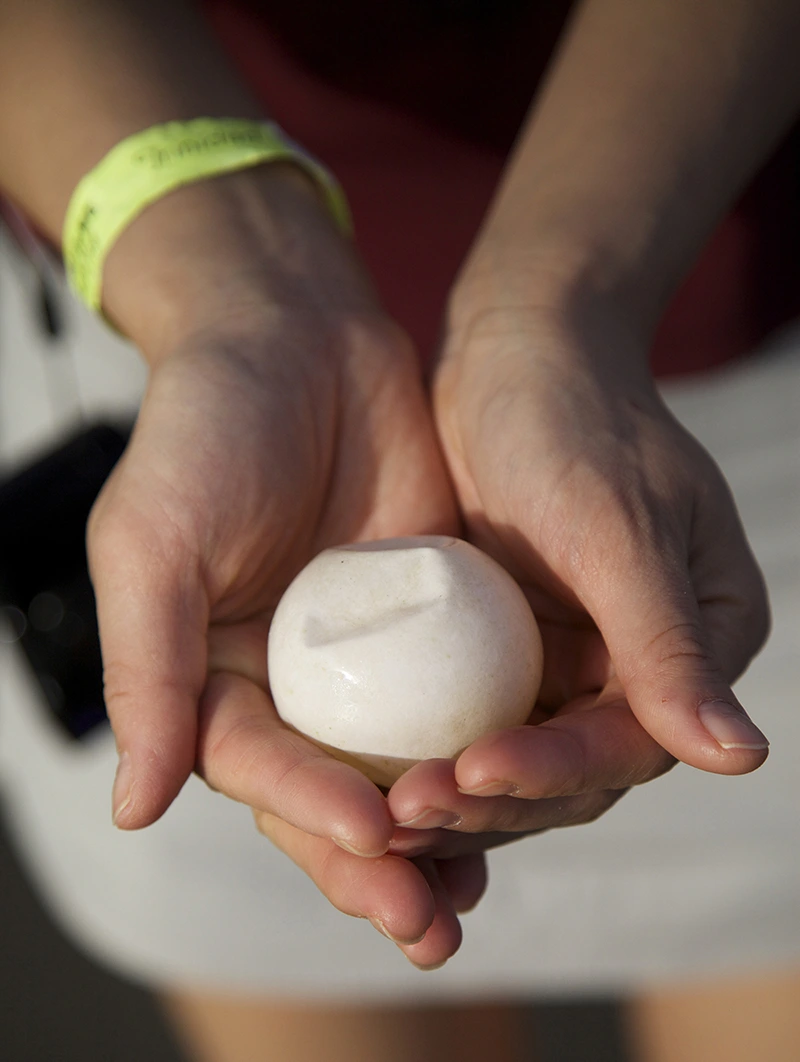 Joyce holding a leatherback turtle egg that was inadvertently dug up by a nesting turtle.